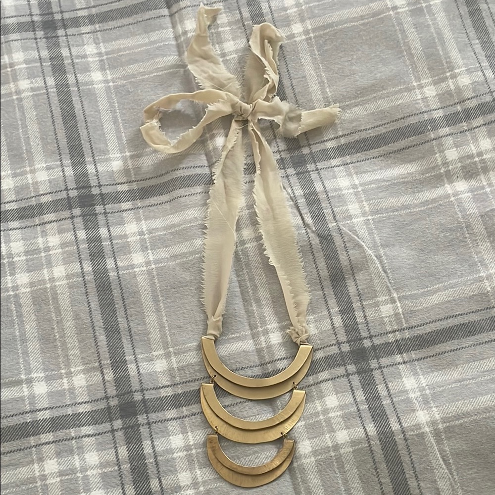 Elegant Gold Necklace with Cream Ribbon